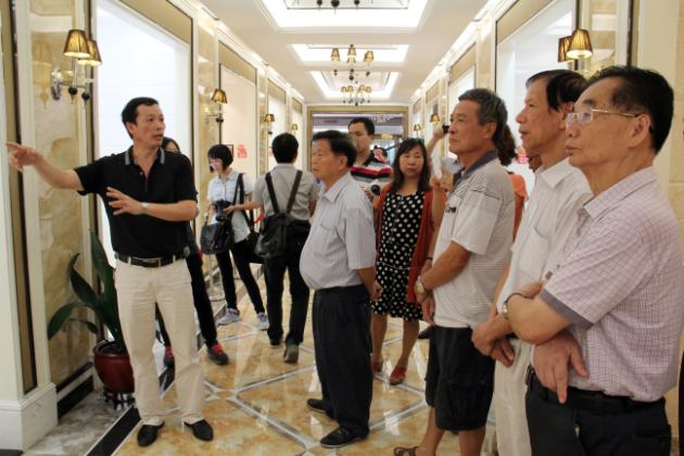 圖3、宏陶市場總監(jiān)霍達炎（左一）在為參觀者介紹釉面磚展示空間.jpg